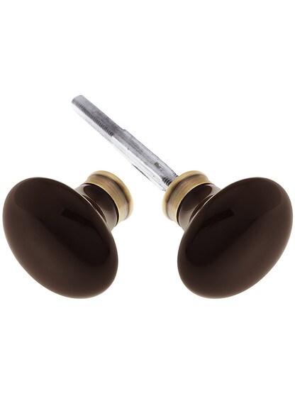 Pair of Brown Porcelain Knobs in Antique Brass.